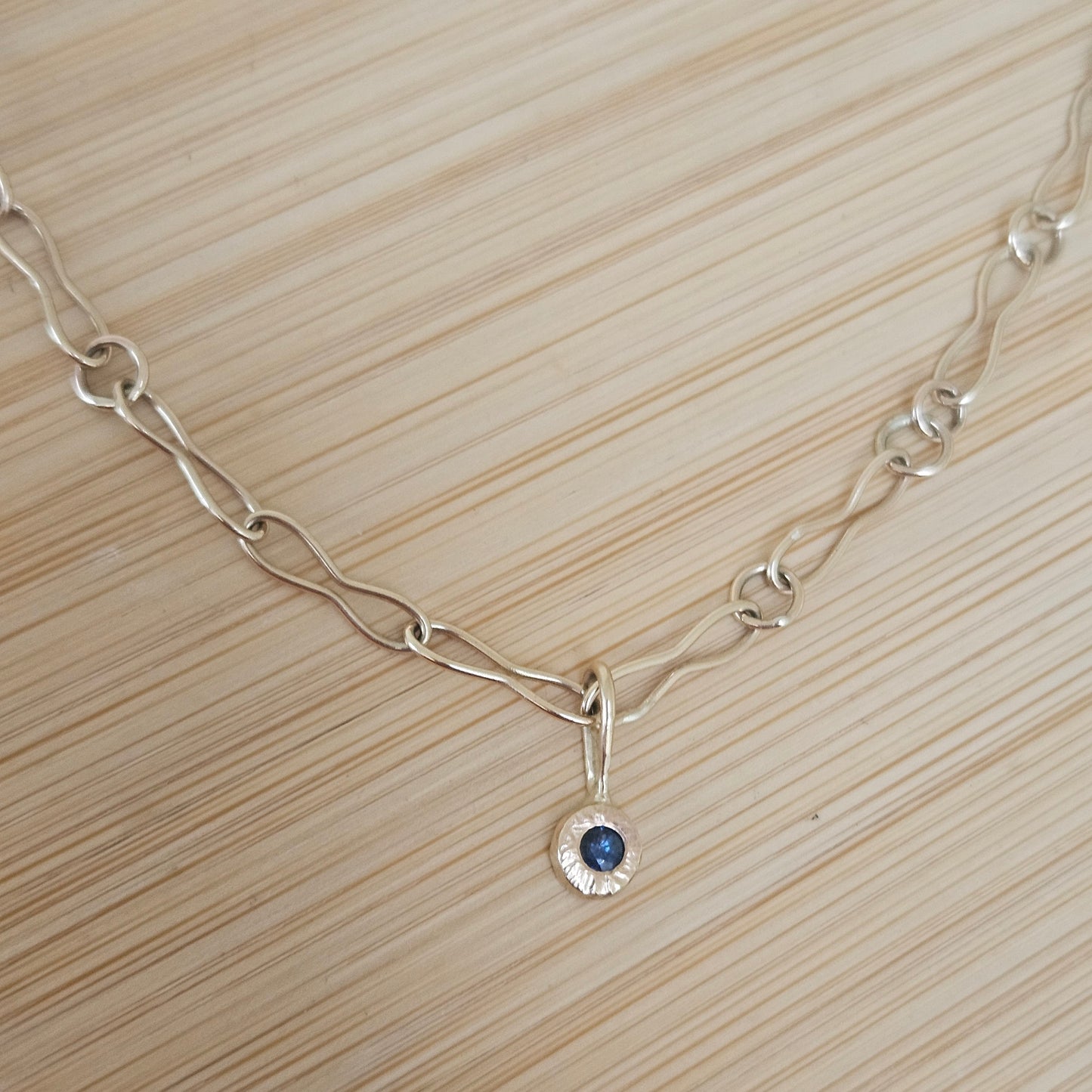 9ct handmade gold chain with a sapphire charm