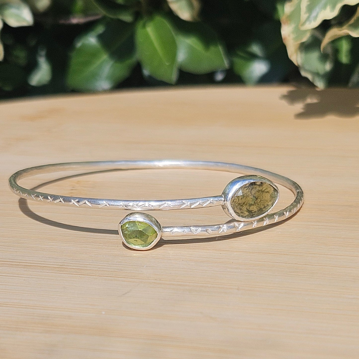 Sterling silver bangle with moldavite and peridot