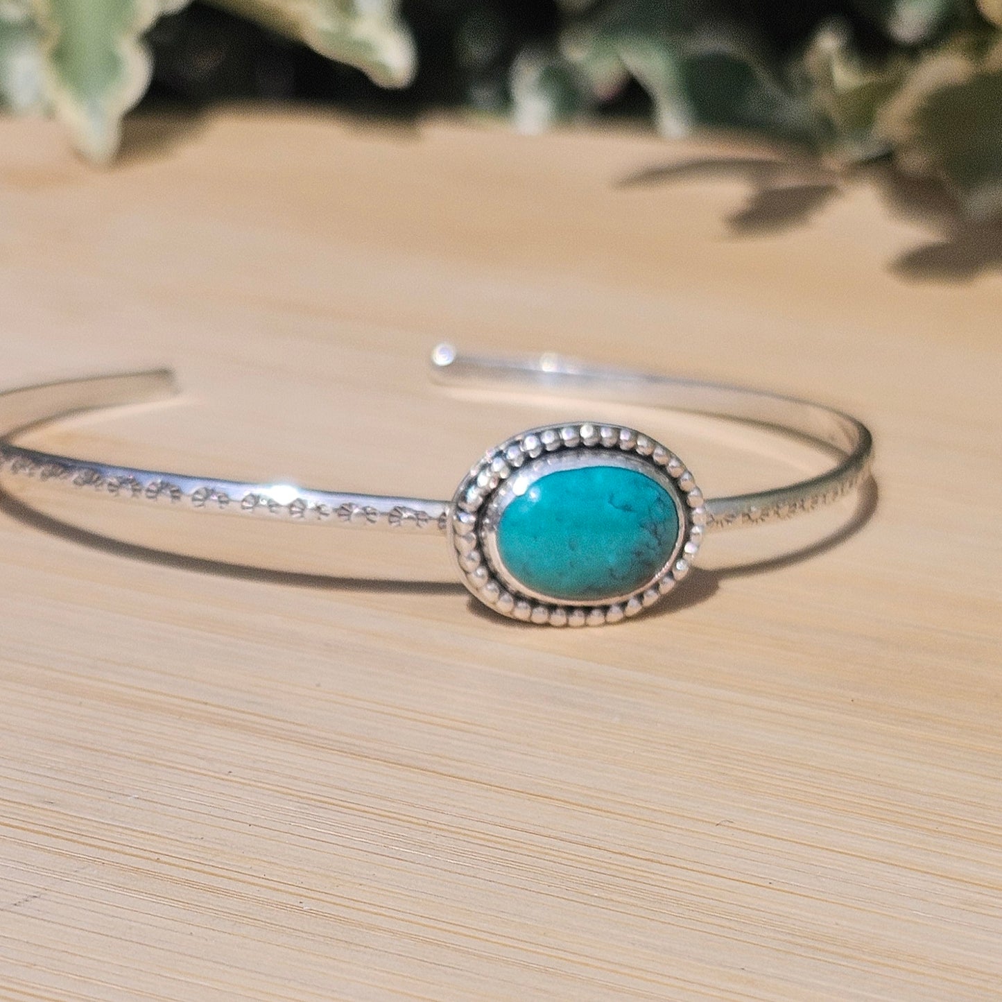 Sterling silver cuff style bangle with a turquoise