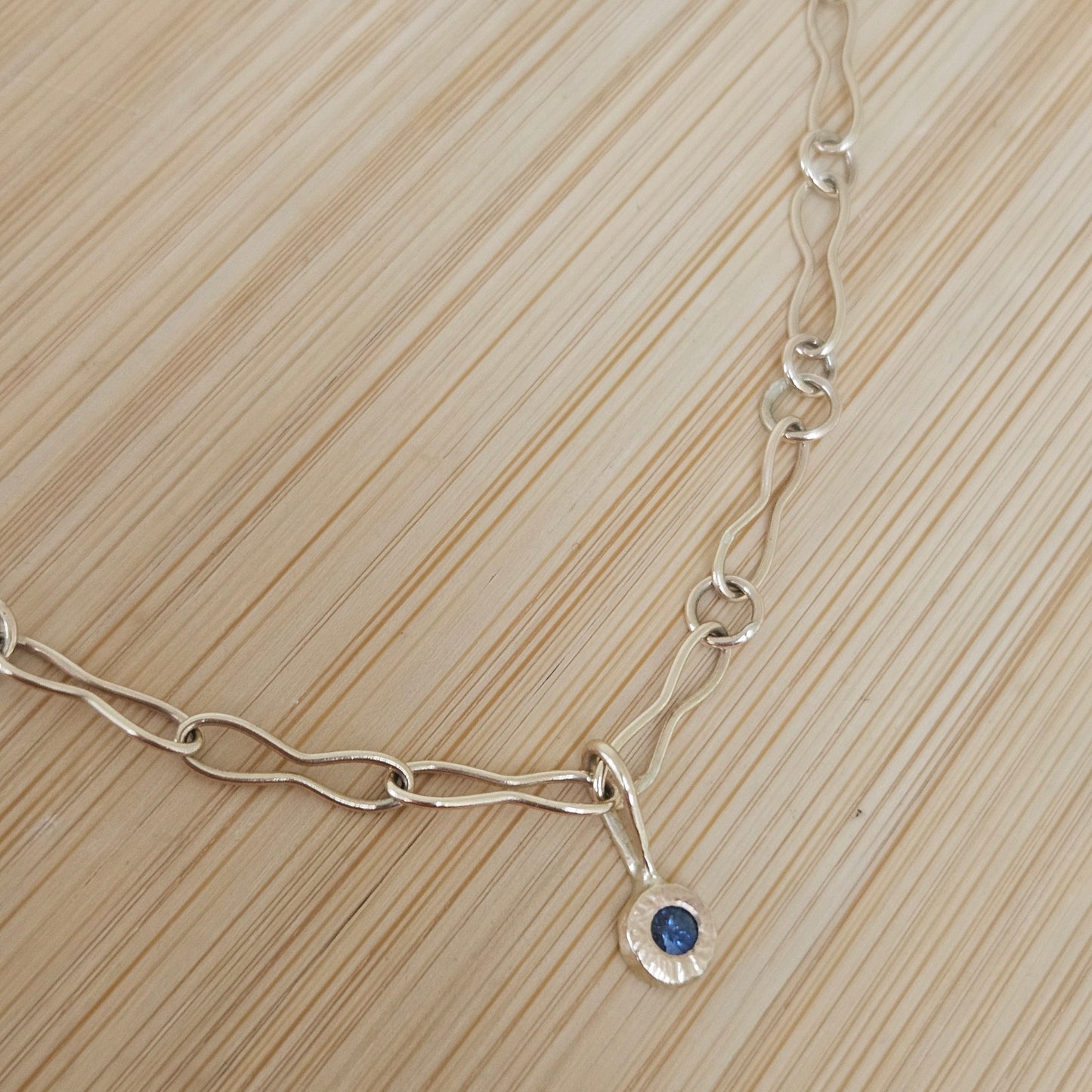 9ct handmade gold chain with a sapphire charm