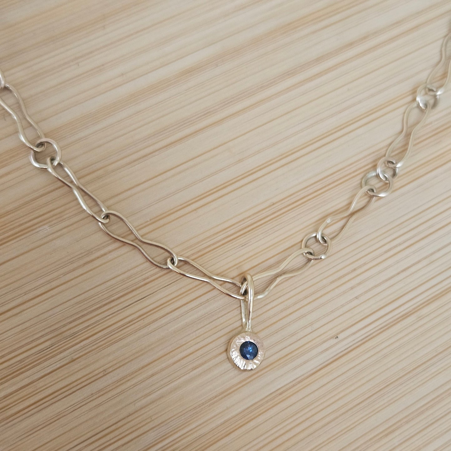 9ct handmade gold chain with a sapphire charm