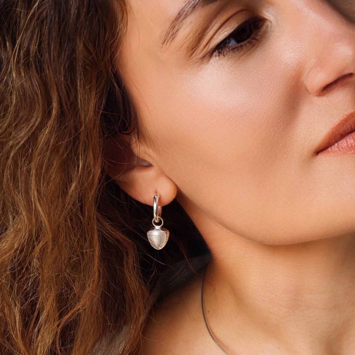 Pearl huggie earrings in sterling silver