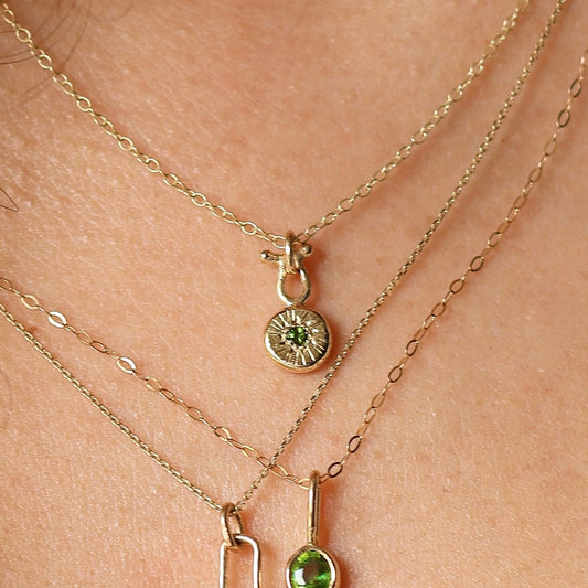 9ct gold pendant with a 2mm green sapphire