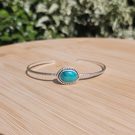 Sterling silver cuff style bangle with a turquoise
