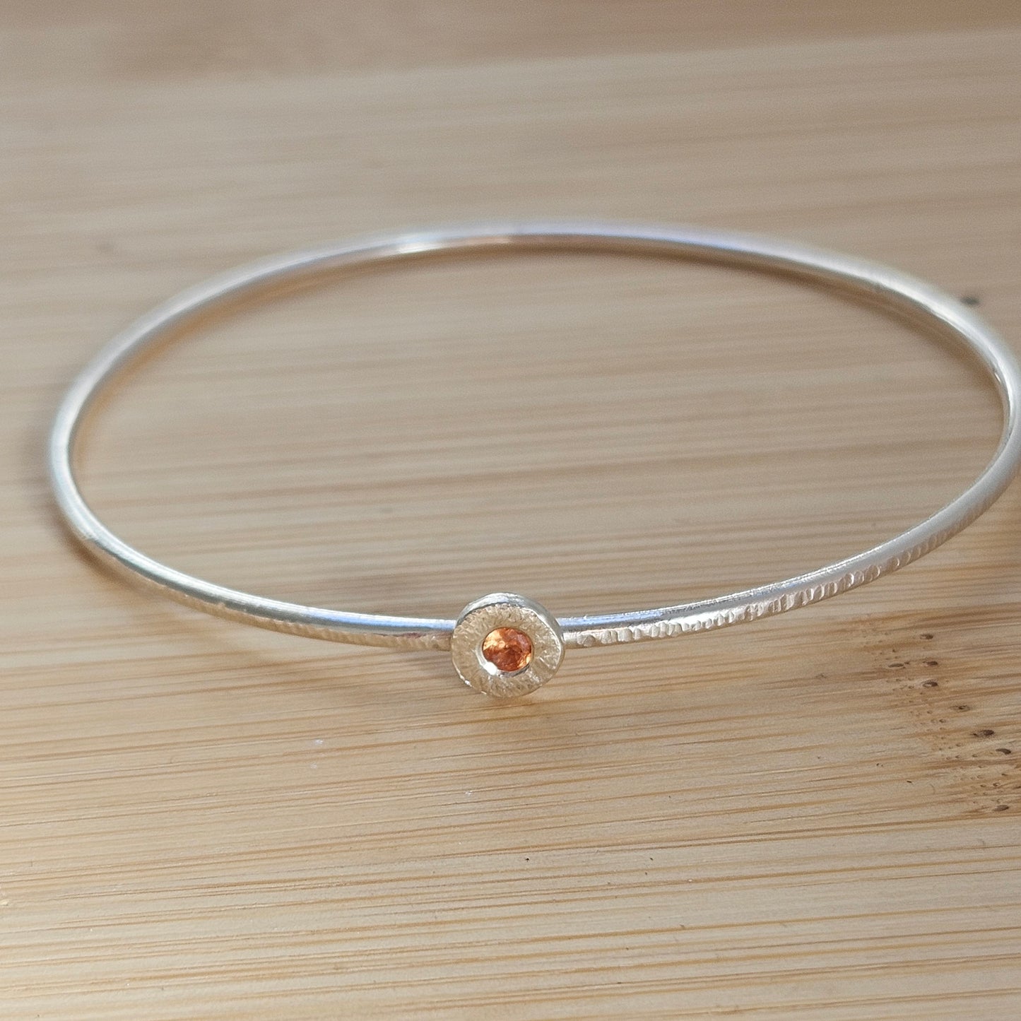 Silver bangle with sapphire