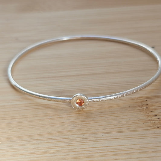 Silver bangle with sapphire