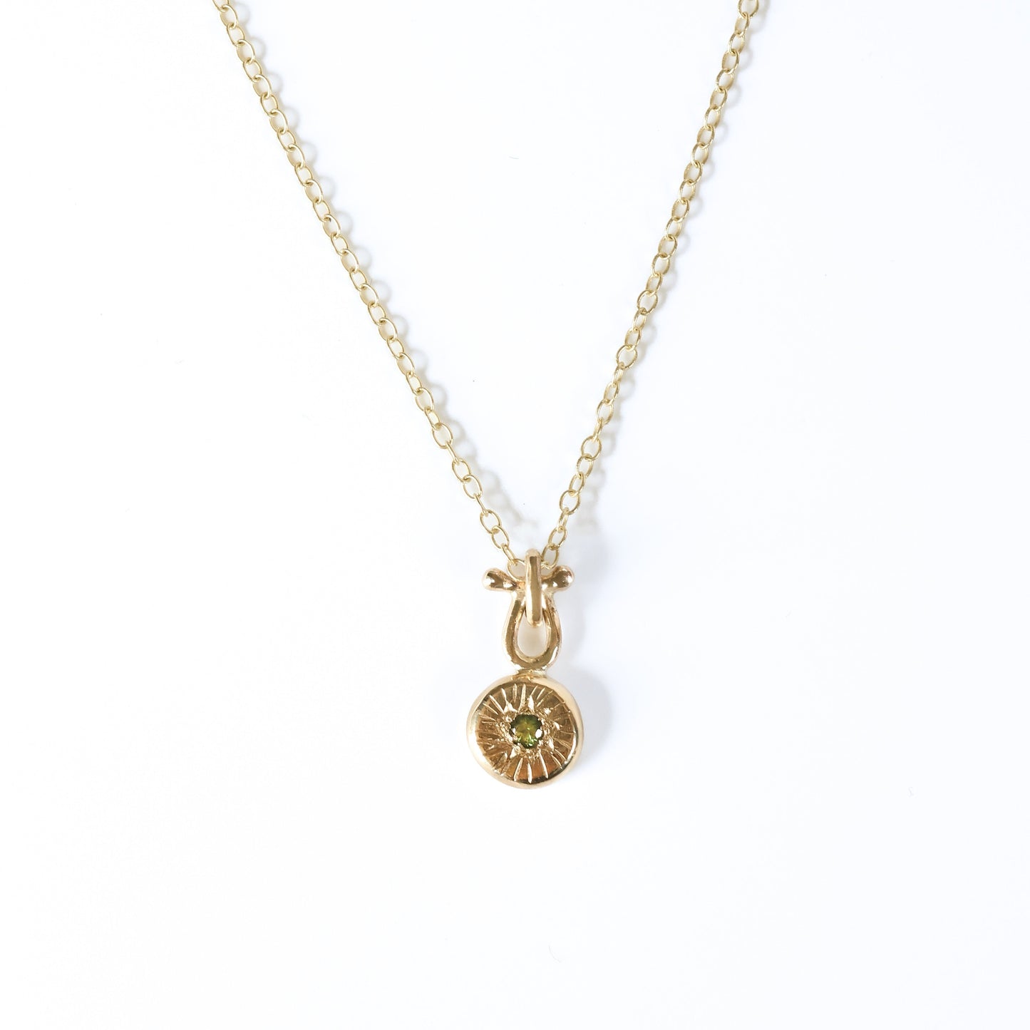 9ct gold pendant with a 2mm green sapphire