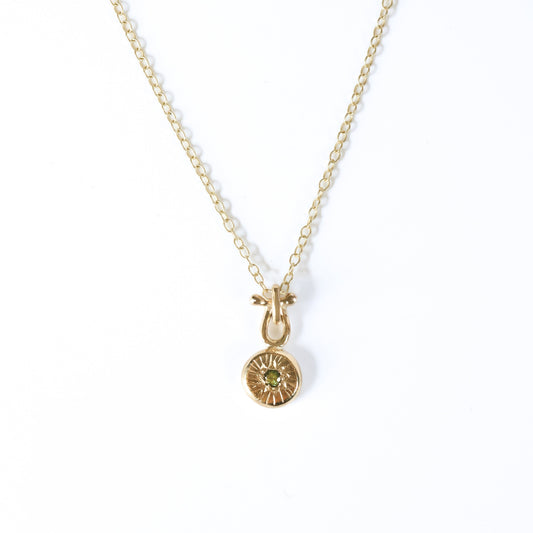 9ct gold pendant with a 2mm green sapphire